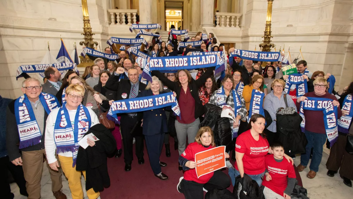 NEARI members pose for a group photo in the Capitol on Lobby Day 2024 holding up NEARI scarves.