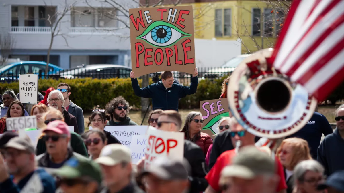 Rally goers at the Rally for Working People one holding a sign We the People