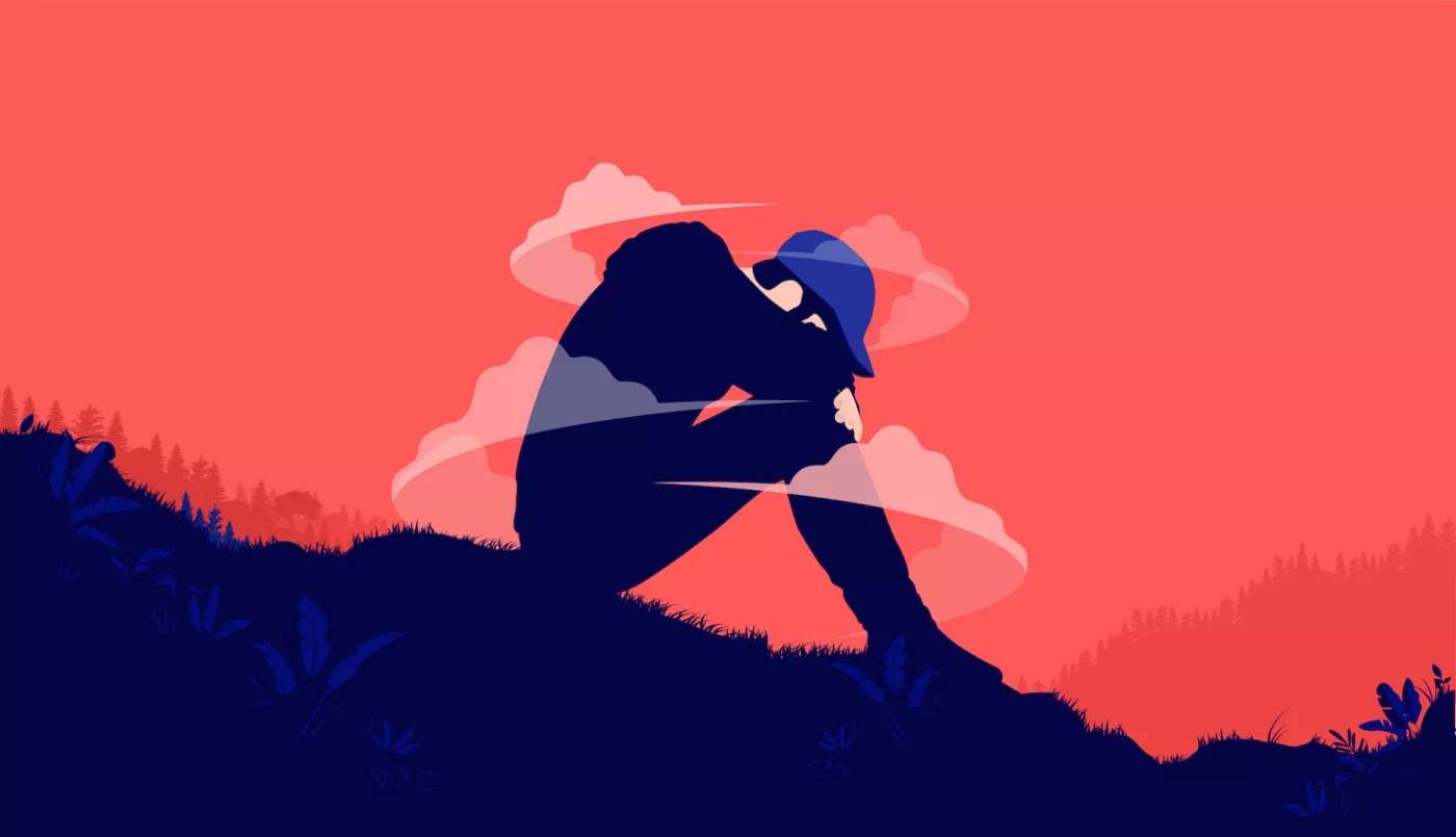 An illustration of a teenager sitting on a hill with their head on their knees. They appear to be crying and are surrounded by small clouds.