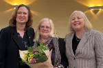 Angela Boisclair awarded Teaching Excellence Award 2024 receives flowers from Mary Barden and Val Lawson