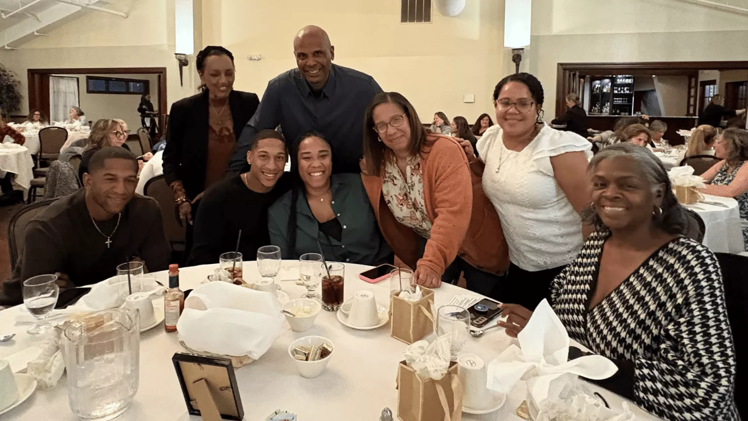 Large grouping of family smiling at a dinner table