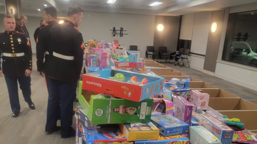 US Marine Reservists looking at table piled with toys at toy drive