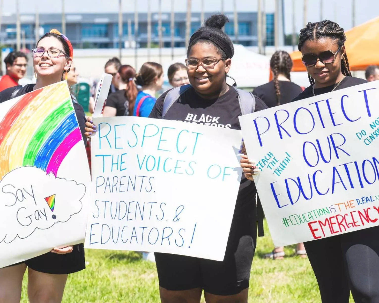 RA attendees hold signs supporting LGBTQ+ students