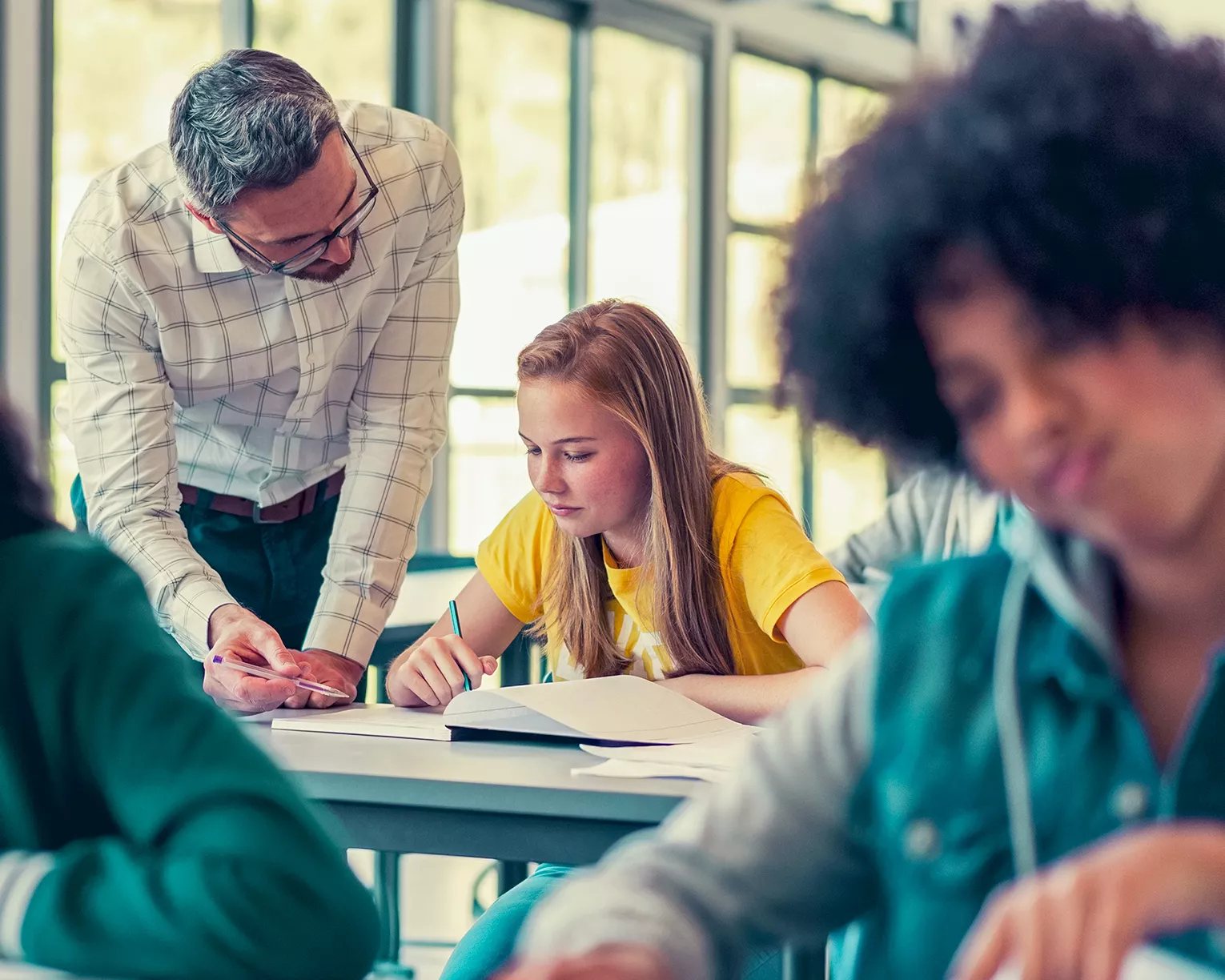 A teacher helping a student in class