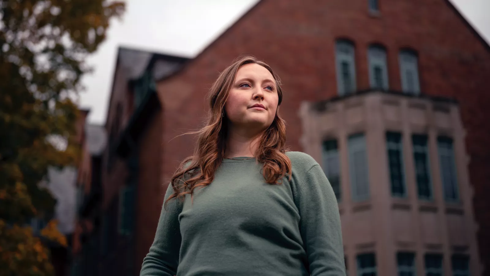 Reagan Williams stands in front a building on campus