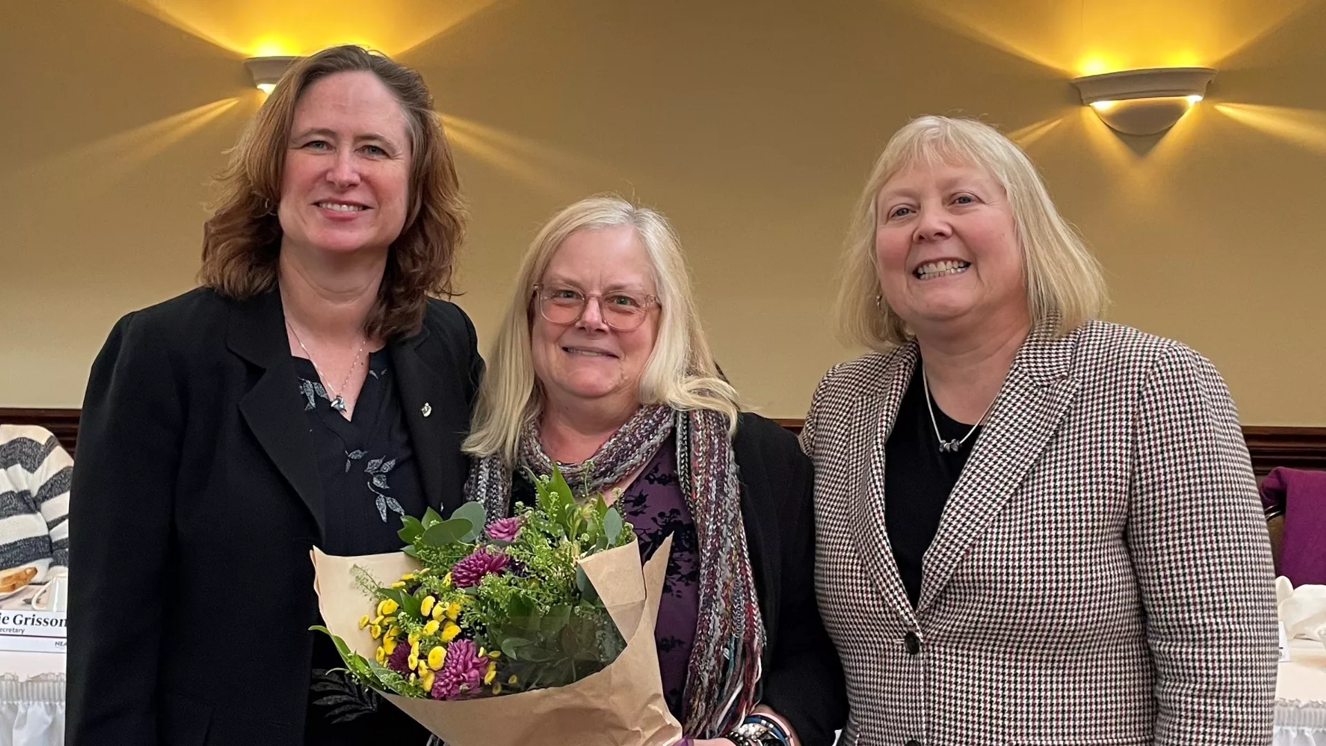 Angela Boisclair awarded Teaching Excellence Award 2024 receives flowers from Mary Barden and Val Lawson
