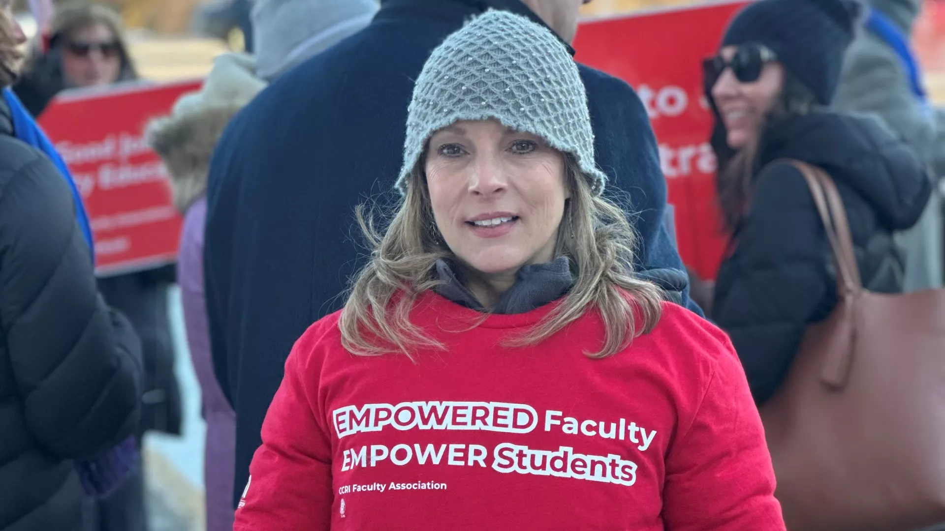 A faculty member on the picket line with a shirt that reads "Empowered Faculty empower students"