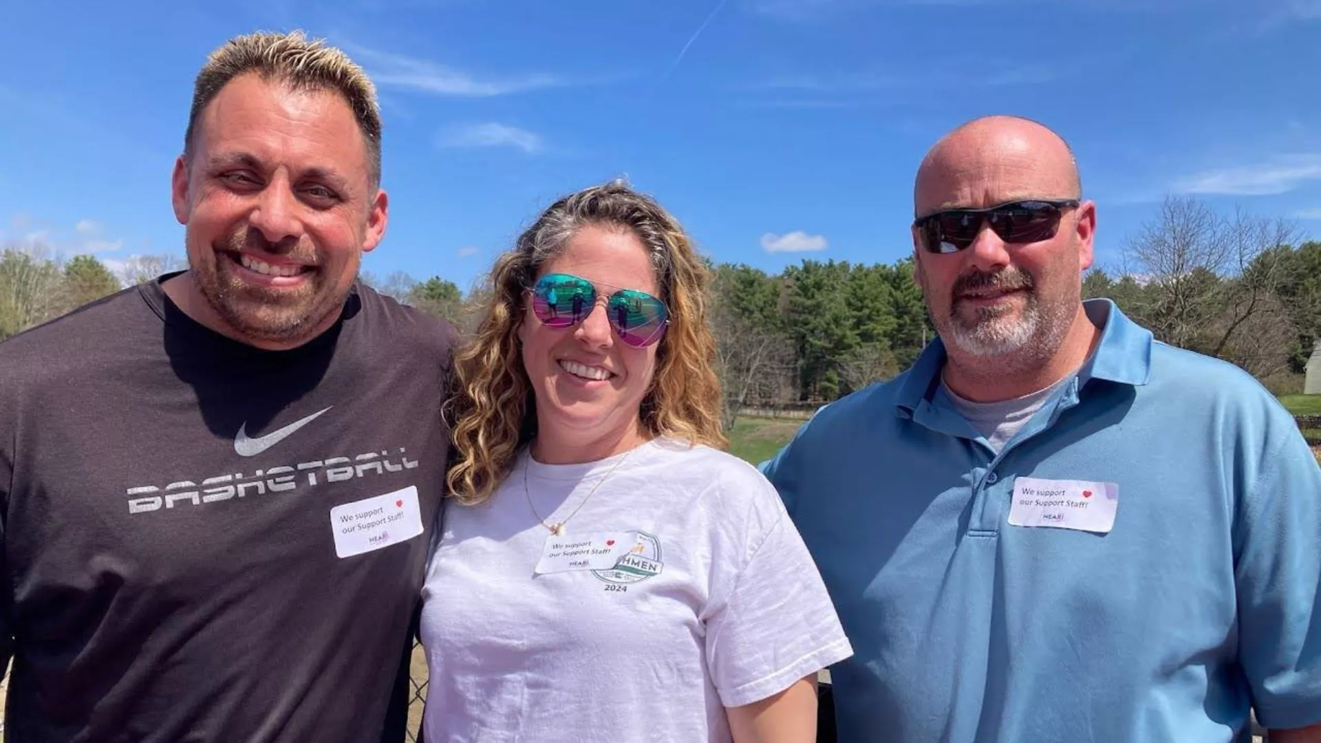 three N. Smithfield educators wear stickers of support for the support staff of their school community