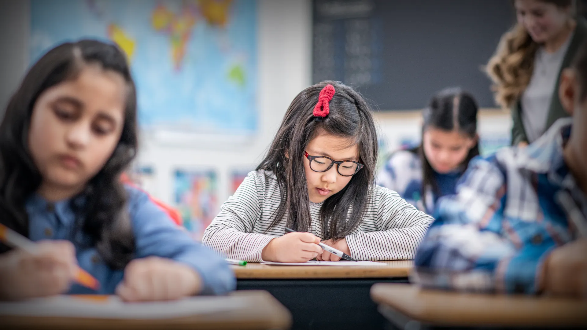 student working at classroom desk