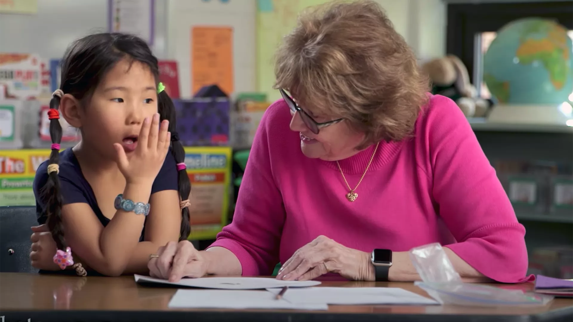 Teacher working with student on reading instruction