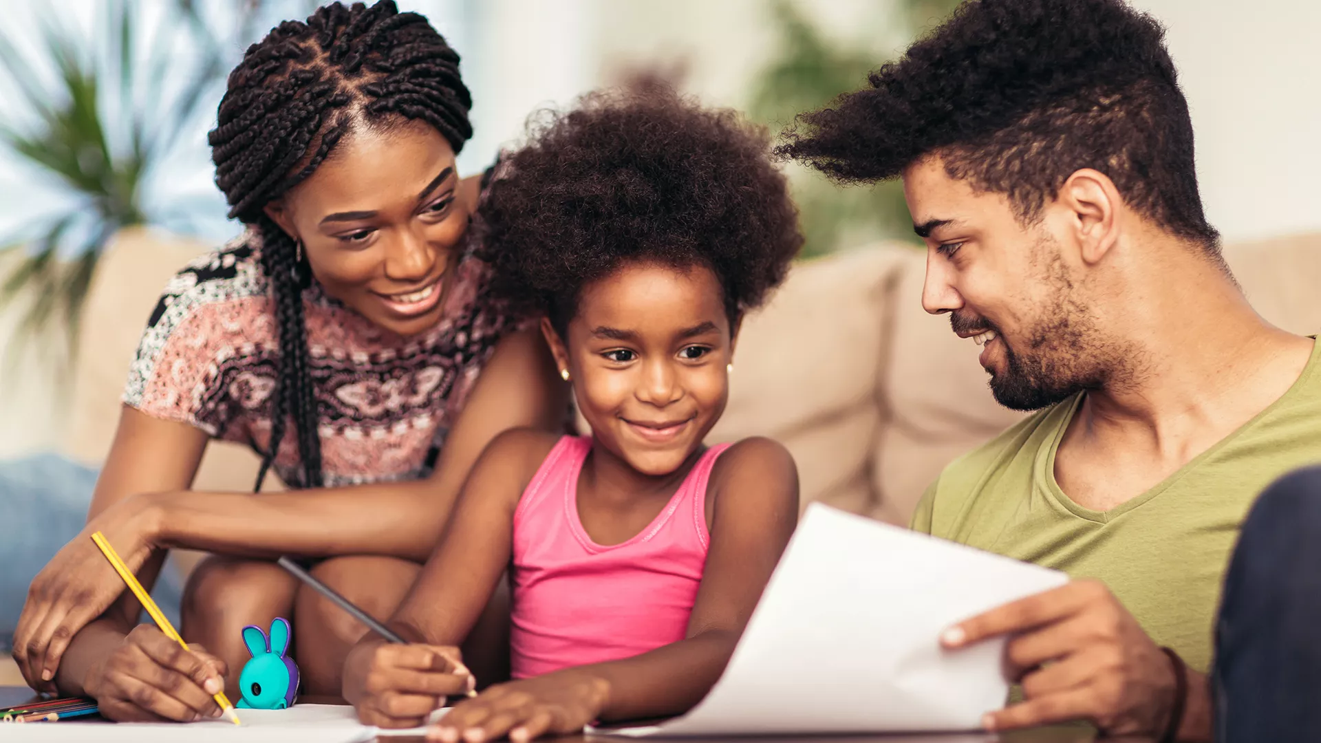 mother and father helping child with homework