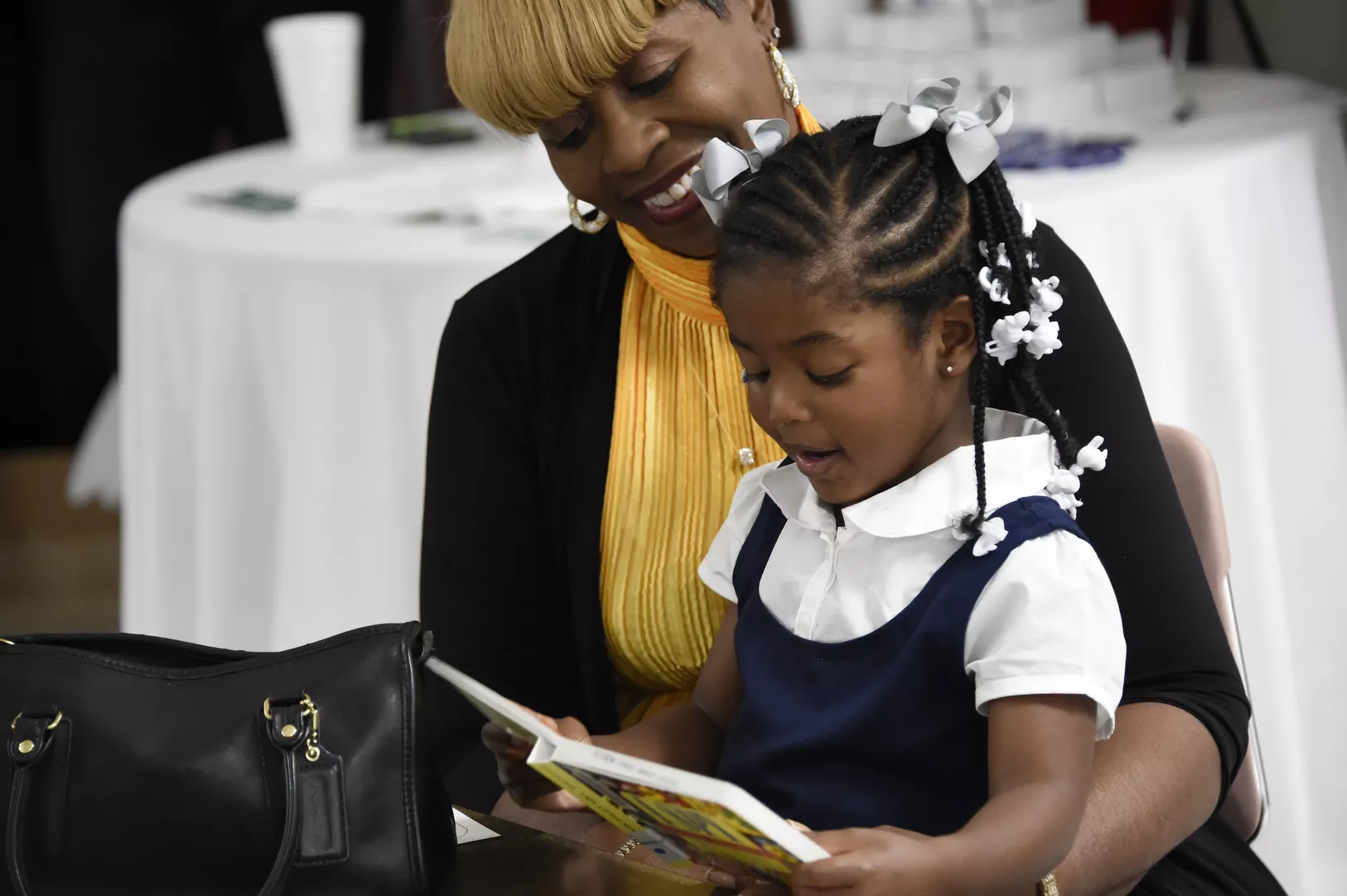 Child and adult reading together