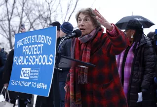 Randi Weingarten speaks to a crowd at a rally.