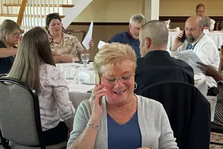 NEARI members at a dinner are all calling legislators on their cell phones.