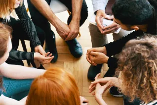 teenagers in group therapy session sitting in circle