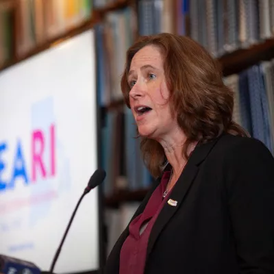 Mary Barden speaking into a microphone at the 2024 Lobby Day event