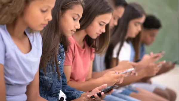 children looking at cell phones