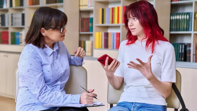 counselor and patient talking intently in an office