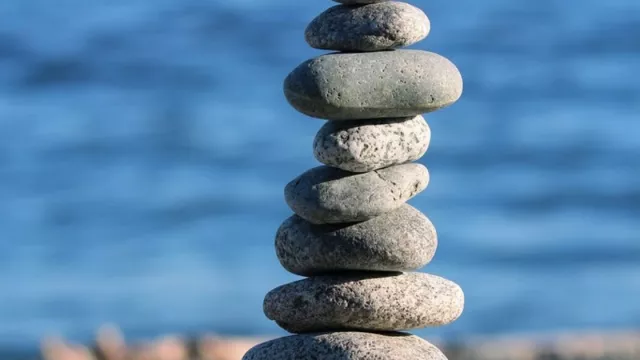 A rock cairn with a body of water in the background