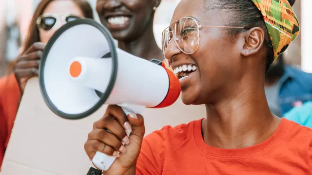 Young Black educator with bullhorn