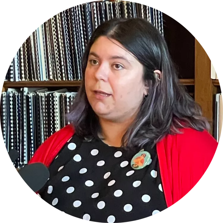 Music Educator Chelsea Anderson stands at a microphone at the Rhode Island Statehouse to give remarks at a 2024 Press Conference for Healthy School Meals for All.