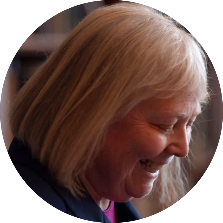 President Valerie Lawson smiles as she looks down at a podium during a press conference on Lobby Day 2024.